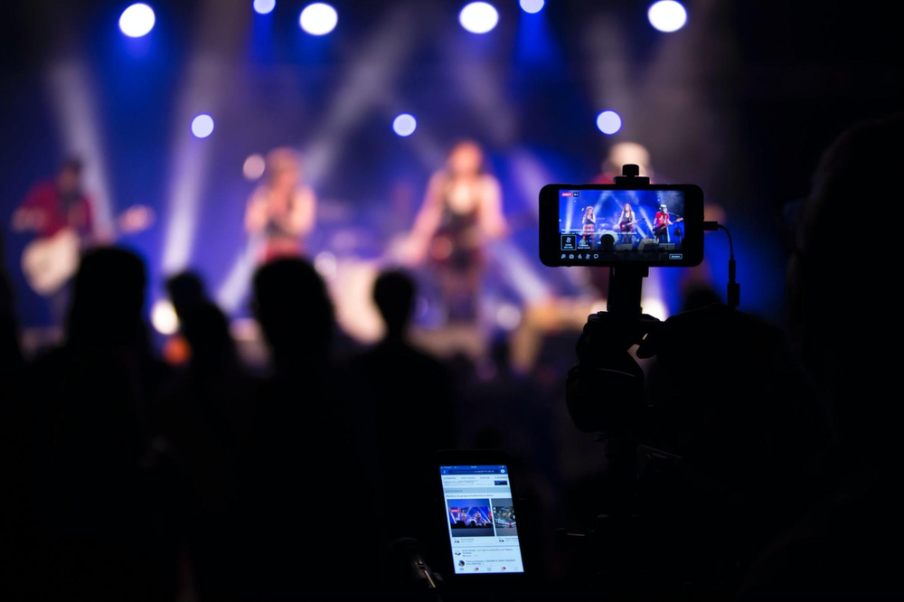 someone filming a concert