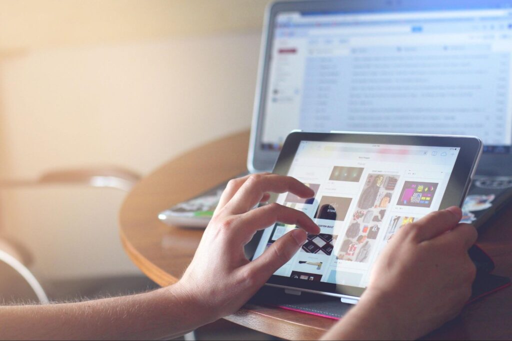a person using a laptop and a tablet