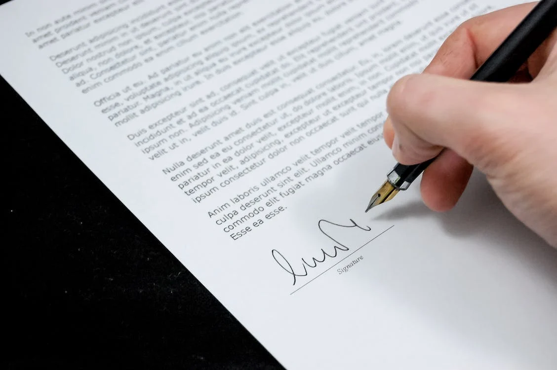 someone signing a document