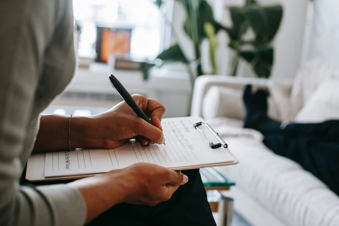 a woman writing on a clipboard