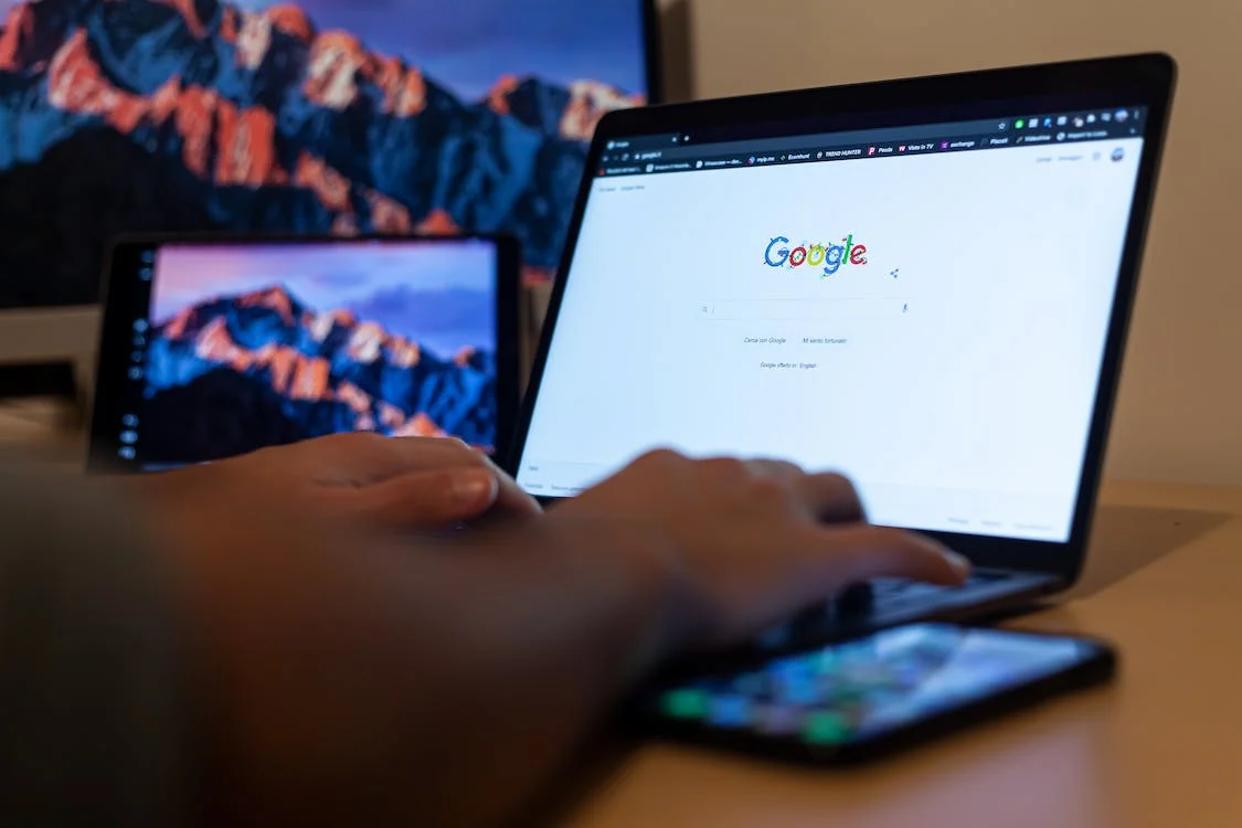 a person searching on goodle on a laptop